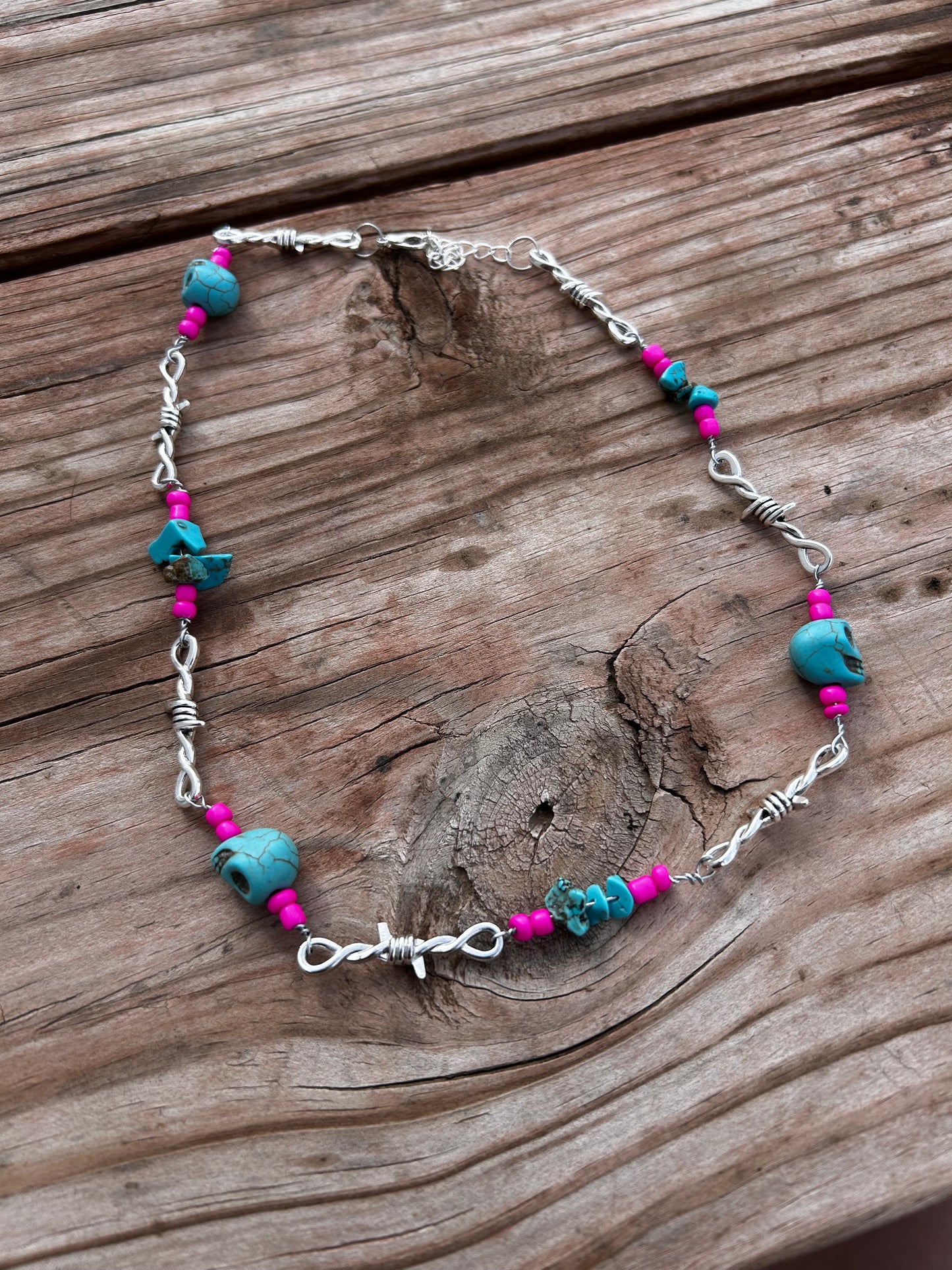 Pink and turquoise skull barbed wire necklace