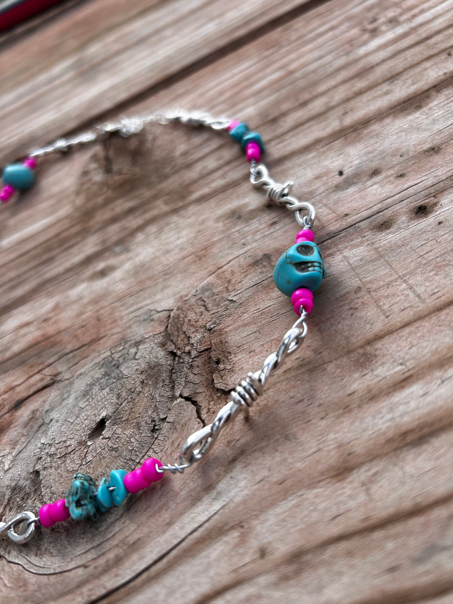 Pink and turquoise skull barbed wire necklace